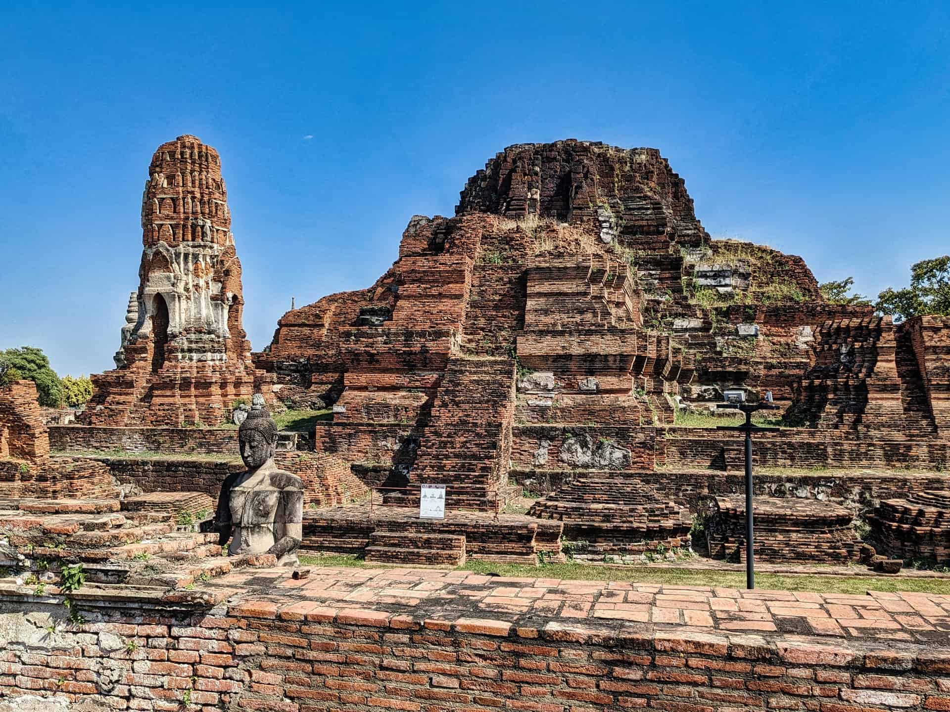 Wat Mahathat Ayutthaya Buddha s Head In Tree Roots TIMEtoMOSEY wat-mahathat-ayutthaya-buddha-s-head-in-tree-roots-timetomosey